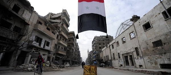 A Syrian national flag hangs in a damaged neighbourhood in Aleppo, Syria A Syrian national flag hangs in a damaged neighbourhood in Aleppo, Syria - Sputnik International