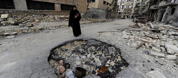 Syrian woman walks past a destroyed building in Aleppo Syrian woman walks past a destroyed building in Aleppo - Sputnik International