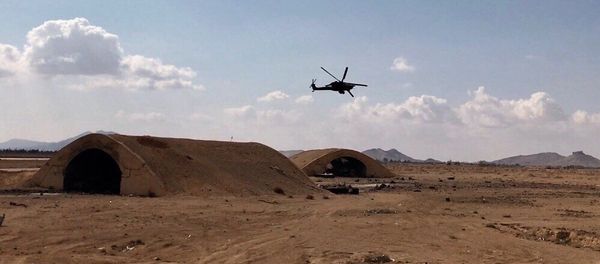 Russia's Mi-28 helicopter flies over the environs of Ancient Palmyra in Homs Governorate, Syria. File photo - Sputnik International