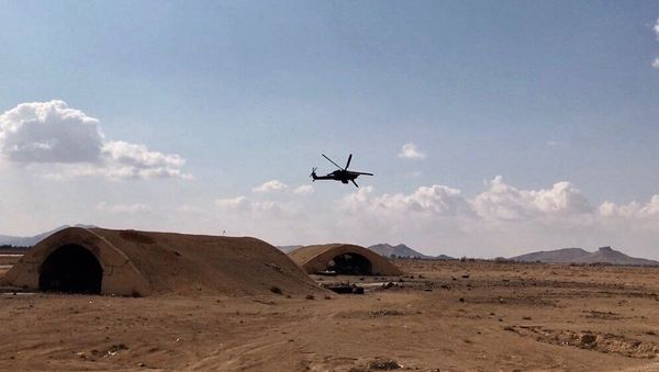 An Mi-28 helicopter flies over the environs of Ancient Palmyra in Homs Governorate, Syria - Sputnik International