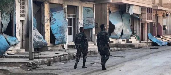 Soldiers walk past buildings destroyed during combat activities in the residential part of Ancient Palmyra in Homs Governorate, Syria Soldiers walk past buildings destroyed during combat activities in the residential part of Ancient Palmyra in Homs Governorate, Syria - Sputnik International