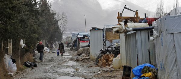 Syrian refugees walking at an unofficial refugee camp near a snow covered mountain in the village of Deir Zannoun in Lebanon's Bekaa valley. Syrian refugees walking at an unofficial refugee camp near a snow covered mountain in the village of Deir Zannoun in Lebanon's Bekaa valley. - Sputnik International