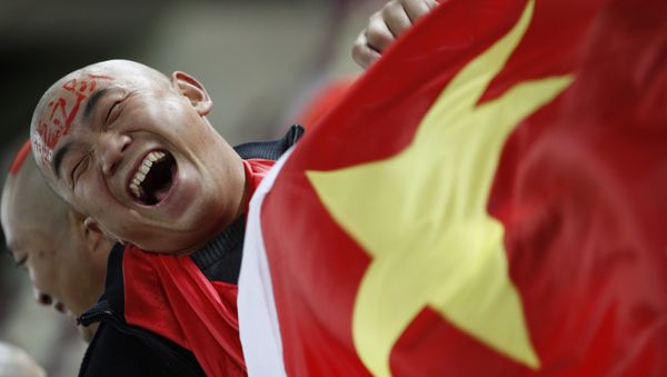 In this Wednesday, Jan. 12, 2011, file photo, a Chinese soccer fan cheers for his team before their AFC Asian Cup group A soccer match against Qatar in Doha, Qatar. In this Wednesday, Jan. 12, 2011, file photo, a Chinese soccer fan cheers for his team before their AFC Asian Cup group A soccer match against Qatar in Doha, Qatar. - Sputnik International