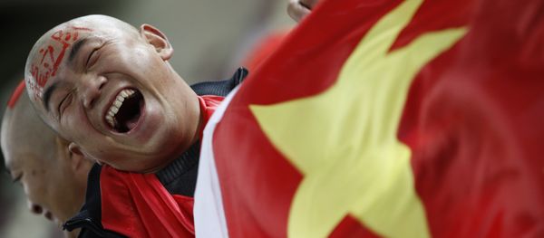 In this Wednesday, Jan. 12, 2011, file photo, a Chinese soccer fan cheers for his team before their AFC Asian Cup group A soccer match against Qatar in Doha, Qatar. In this Wednesday, Jan. 12, 2011, file photo, a Chinese soccer fan cheers for his team before their AFC Asian Cup group A soccer match against Qatar in Doha, Qatar. - Sputnik International