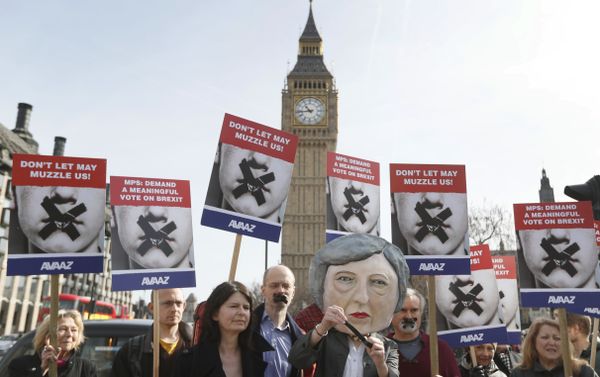 Demonstrators, one dressed in a Theresa May puppet head pose near parliament in London Demonstrators, one dressed in a Theresa May puppet head pose near parliament in London - Sputnik International