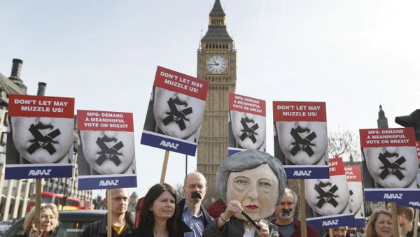 Demonstrators, one dressed in a Theresa May puppet head pose near parliament in London Demonstrators, one dressed in a Theresa May puppet head pose near parliament in London - Sputnik International