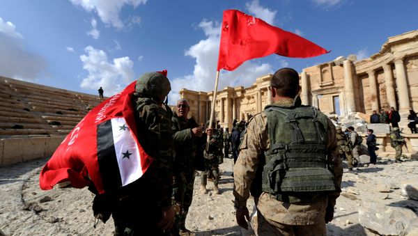 Syrian army soldiers carry flags in the amphitheater of the historic city of Palmyra, Syria March 4, 2017. Syrian army soldiers carry flags in the amphitheater of the historic city of Palmyra, Syria March 4, 2017. - Sputnik International