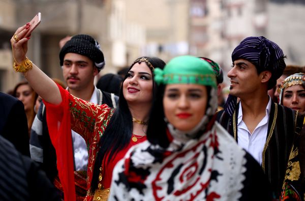 The models showcased shimmering dresses of contrasting patterns during a fashion show aimed at reviving the minority's traditional clothing. The models showcased shimmering dresses of contrasting patterns during a fashion show aimed at reviving the minority's traditional clothing. - Sputnik International