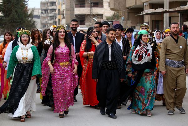 A group of Syrian-Kurdish men and women dressed in traditional Kurdish attire walk down the street in the northeastern Syrian city of Qamishli celebrating the Day of Kurdish Clothing. A group of Syrian-Kurdish men and women dressed in traditional Kurdish attire walk down the street in the northeastern Syrian city of Qamishli celebrating the Day of Kurdish Clothing. - Sputnik International