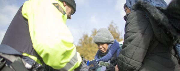 An RCMP officer checks the documents of two women from Sudan after they illegally crossed the Canada-US border. (File) An RCMP officer checks the documents of two women from Sudan after they illegally crossed the Canada-US border. (File) - Sputnik International