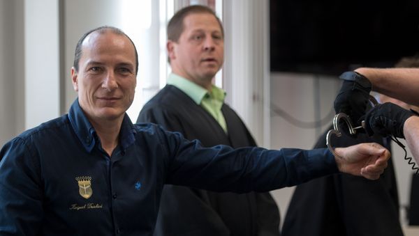 Self-appointed King of Germany Peter Fitzek (L) is taken off the handcuffs as he arrives for his trial at court in Halle/Saale, central Germany, on March 15, 2017 Self-appointed King of Germany Peter Fitzek (L) is taken off the handcuffs as he arrives for his trial at court in Halle/Saale, central Germany, on March 15, 2017 - Sputnik International