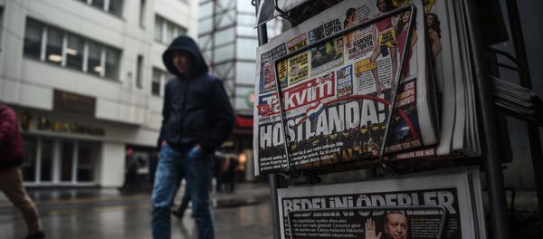 A person walks past a newspaper stand showing their front pages bearing headlines concerning diplomatic tensions between Turkey and The Netherlands, on display in Istanbul on March 13, 2017 A person walks past a newspaper stand showing their front pages bearing headlines concerning diplomatic tensions between Turkey and The Netherlands, on display in Istanbul on March 13, 2017 - Sputnik International