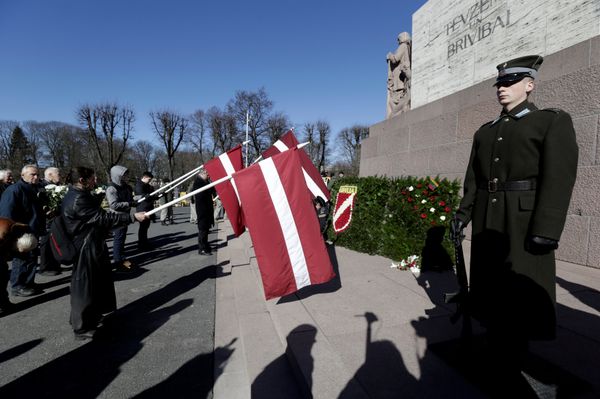 People hold flags, as they participate in the annual procession commemorating the Latvian Waffen-SS (Schutzstaffel) unit, also known as the Legionnaires, in Riga, Latvia March 16, 2017 People hold flags, as they participate in the annual procession commemorating the Latvian Waffen-SS (Schutzstaffel) unit, also known as the Legionnaires, in Riga, Latvia March 16, 2017 - Sputnik International