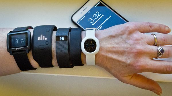 Fitness trackers, from left, Basis Peak, Adidas Fit Smart, Fitbit Charge, Sony SmartBand, and Jawbone Move, are posed for a photo next to an iPhone, in New York (File) Fitness trackers, from left, Basis Peak, Adidas Fit Smart, Fitbit Charge, Sony SmartBand, and Jawbone Move, are posed for a photo next to an iPhone, in New York (File) - Sputnik International