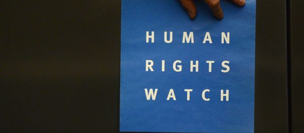 A man puts a logo of US-based rights group Human Rights Watch on the wall as he prepares the room before their press conference to release their annual World report on January 21, 2014 in Berlin A man puts a logo of US-based rights group Human Rights Watch on the wall as he prepares the room before their press conference to release their annual World report on January 21, 2014 in Berlin - Sputnik International