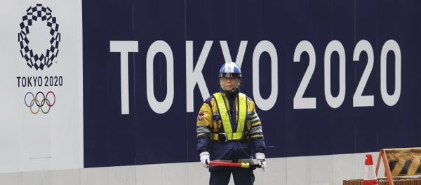 A security guard stands in front of an official logo of the 2020 Tokyo Olympic Games on the safety wall at a construction site in Tokyo's Nihonbashi shopping and office district, Monday, Feb. 6, 2017 A security guard stands in front of an official logo of the 2020 Tokyo Olympic Games on the safety wall at a construction site in Tokyo's Nihonbashi shopping and office district, Monday, Feb. 6, 2017 - Sputnik International