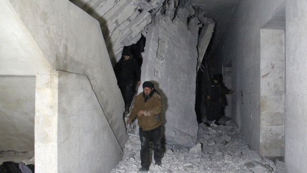 Syrians inspect the inside of a mosque following a reported airstrike in the village of Al-Jineh in Aleppo province late on March 16, 2017 - Sputnik International