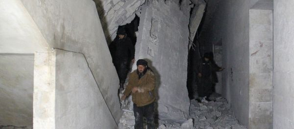 Syrians inspect the inside of a mosque following a reported airstrike in the village of Al-Jineh in Aleppo province late on March 16, 2017 - Sputnik International