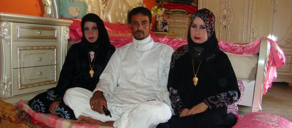 Abdul Rahman al-Obeidi, a 22 year-old Iraqi farmer, sits between his two new wives on April 25, 2012 in Samarra - Sputnik International