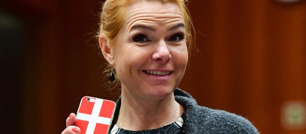 Danish Interior Minister Inger Stojberg holds her phone showing a Danish flags as she attends a Justice and Home Affairs Council at the European Council in Brussels on November 18, 2016 Danish Interior Minister Inger Stojberg holds her phone showing a Danish flags as she attends a Justice and Home Affairs Council at the European Council in Brussels on November 18, 2016 - Sputnik International
