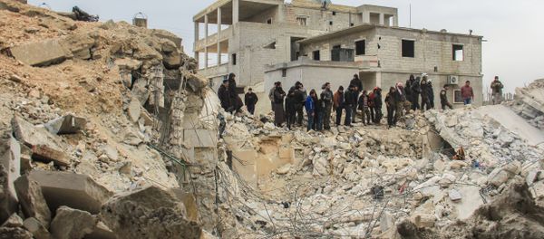 People stand by as Syrian civil defence volunteers, known as the White Helmets, dig through the rubble of a mosque following a reported airstrike on a mosque in the village of Al-Jineh in Aleppo province on March 17, 2017 People stand by as Syrian civil defence volunteers, known as the White Helmets, dig through the rubble of a mosque following a reported airstrike on a mosque in the village of Al-Jineh in Aleppo province on March 17, 2017 - Sputnik International