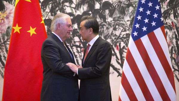 U.S. Secretary of State Rex Tillerson, left, and Chinese Foreign Minister Wang Yi stare at each other as they shake hands at the end of a joint press conference following their meeting at the Diaoyutai State Guesthouse in Beijing, China, Saturday, March 18, 2017 U.S. Secretary of State Rex Tillerson, left, and Chinese Foreign Minister Wang Yi stare at each other as they shake hands at the end of a joint press conference following their meeting at the Diaoyutai State Guesthouse in Beijing, China, Saturday, March 18, 2017 - Sputnik International
