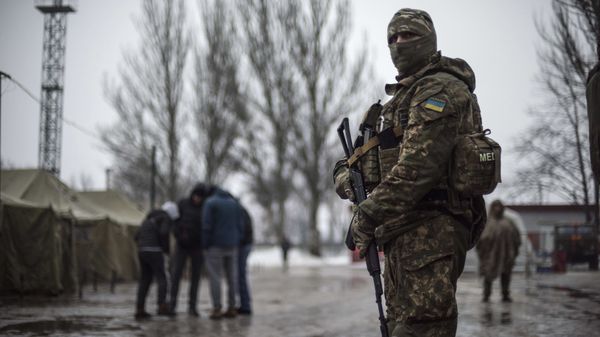 A Ukrainian serviceman patrols at the humanitarian aid center in Avdiivka, Ukraine, Saturday, Feb. 4, 2017 A Ukrainian serviceman patrols at the humanitarian aid center in Avdiivka, Ukraine, Saturday, Feb. 4, 2017 - Sputnik International