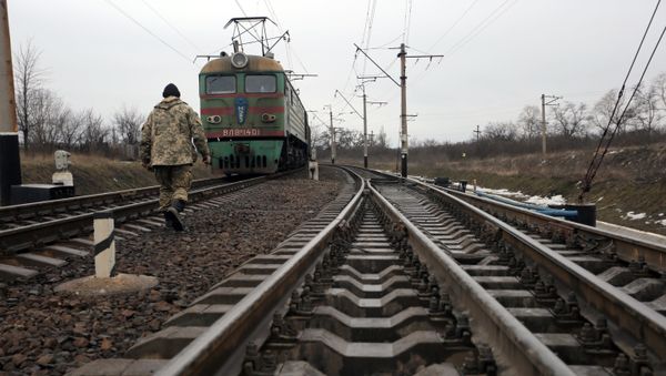 Ukrainian military veteran walks along rails as he takes part in a blockade against ongoing trade with Russian-backed insurgents, on February 23, 2017, in Kryvyi Torets railway station, Donetsk region - Sputnik International