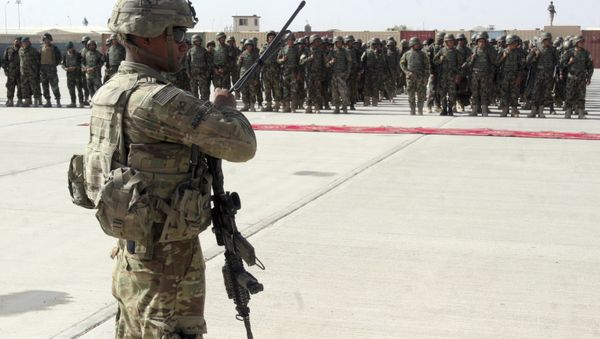In this July 24, 2016 file photo, a US military personal stands guard during a graduation ceremony for Afghan troops, in Lashkargah, capital of southern Helmand province, Afghanistan. In this July 24, 2016 file photo, a US military personal stands guard during a graduation ceremony for Afghan troops, in Lashkargah, capital of southern Helmand province, Afghanistan. - Sputnik International
