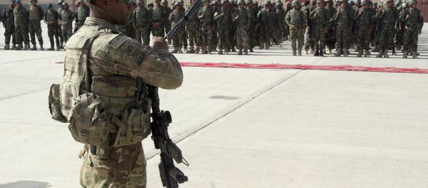 In this July 24, 2016 file photo, a US military personal stands guard during a graduation ceremony for Afghan troops, in Lashkargah, capital of southern Helmand province, Afghanistan. - Sputnik International