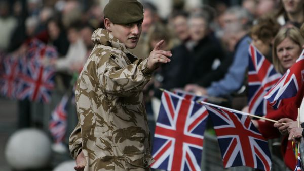 A British soldier from the 2nd Battalion, The Royal Anglian Regiment, talks to people prior to their parade through the town of Watford, England, Wednesday March 11, 2009.  - Sputnik International
