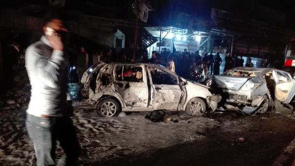 Destroyed cars are seen at the site of a car bomb attack in the Amil neighborhood in Baghdad, Iraq Destroyed cars are seen at the site of a car bomb attack in the Amil neighborhood in Baghdad, Iraq - Sputnik International
