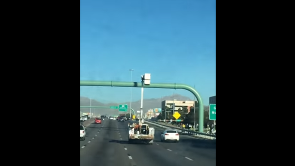 Utility Trucker Drives with Bucket Up - Sputnik International