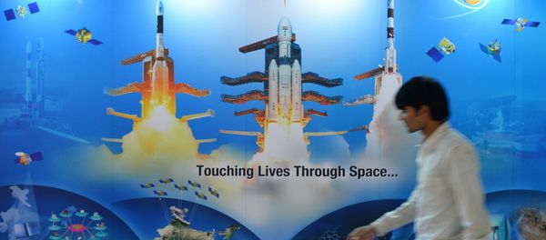 A man walks past a poster of Indian Space Research Organisation (ISRO) - Sputnik International