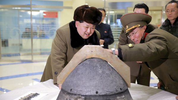 North Korean leader Kim Jong Un looks at a rocket warhead tip after a simulated test of atmospheric re-entry of a ballistic missile, at an unidentified location in this undated file photo released by North Korea's Korean Central News Agency (KCNA) in Pyongyang on March 15, 2016. - Sputnik International