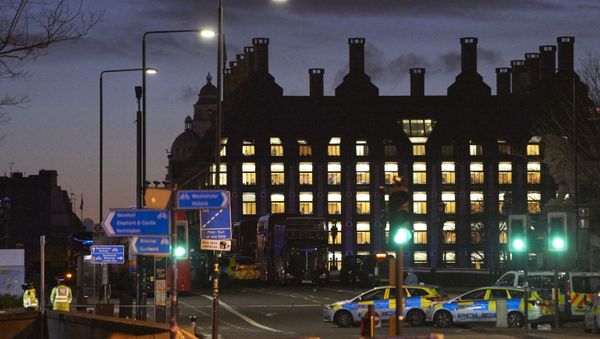 British police officers work on Westminster Bridge, adjacent to the Houses of Parliament in Westminster, central London on March 22, 2017, in the aftermath of a terror incident. British police officers work on Westminster Bridge, adjacent to the Houses of Parliament in Westminster, central London on March 22, 2017, in the aftermath of a terror incident. - Sputnik International