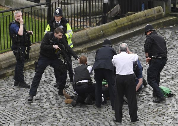 A policeman points a gun at a man on the floor as emergency services attend the scene outside the Palace of Westminster, London, Wednesday, March 22, 2017. - Sputnik International