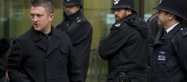 Tommy Robinson, left, the former leader of the far-right EDL English Defence League group walks past police officers as he leaves after an appearance at Westminster Magistrates Court in London, Wednesday, Oct. 16, 2013. Tommy Robinson, left, the former leader of the far-right EDL English Defence League group walks past police officers as he leaves after an appearance at Westminster Magistrates Court in London, Wednesday, Oct. 16, 2013. - Sputnik International