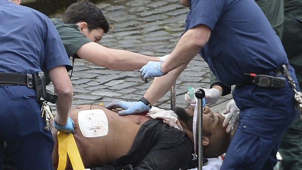 n this March 22, 2017 file photo, the attacker Khalid Masood is treated by emergency services outside the Houses of Parliament London. British Police named on Thursday March 23, 2017, Khalid Masood as The Houses of Parliament attacker. - Sputnik International