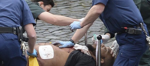 An attacker is treated by emergency services outside the Houses of Parliament London An attacker is treated by emergency services outside the Houses of Parliament London - Sputnik International