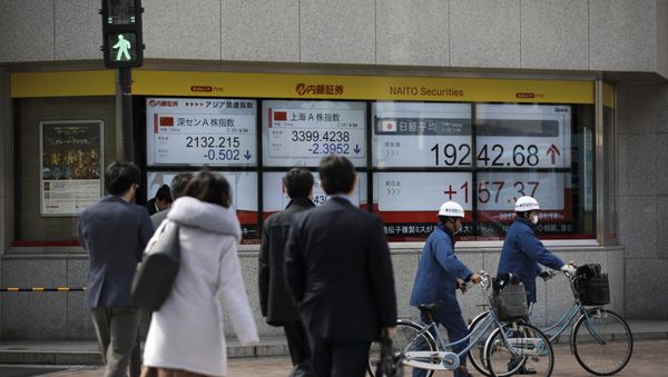 Pedestrians cross a street next to an electric quotation board flashing the Nikkei key index of the Tokyo Stock Exchange (TSE) in Tokyo on March 24, 2017 Pedestrians cross a street next to an electric quotation board flashing the Nikkei key index of the Tokyo Stock Exchange (TSE) in Tokyo on March 24, 2017 - Sputnik International