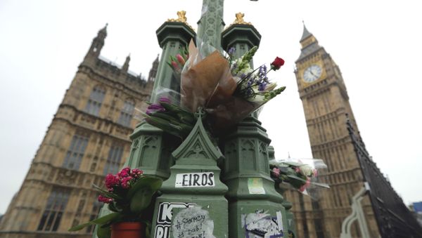 Floral tributes to victims of Wednesday's attack are tied to a lamppost outside the Houses of Parliament in London, Friday March 24, 2017. Floral tributes to victims of Wednesday's attack are tied to a lamppost outside the Houses of Parliament in London, Friday March 24, 2017. - Sputnik International