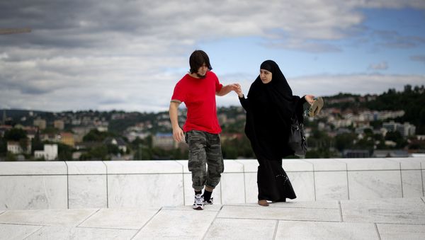 A man helps a woman up a step on the roof of the Opera house in Oslo on August 11 , 2011 A man helps a woman up a step on the roof of the Opera house in Oslo on August 11 , 2011 - Sputnik International