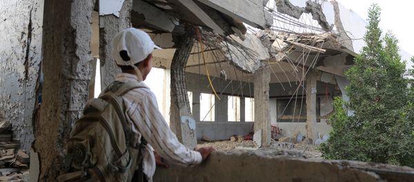 A Yemeni school boy looks at a destroyed school in the Yemeni port city of Hodeidah, on March 15, 2016, which was damaged in the country's ongoing conflict between the Saudi-led Arab coalition fighting Shiite Huthi rebels A Yemeni school boy looks at a destroyed school in the Yemeni port city of Hodeidah, on March 15, 2016, which was damaged in the country's ongoing conflict between the Saudi-led Arab coalition fighting Shiite Huthi rebels - Sputnik International