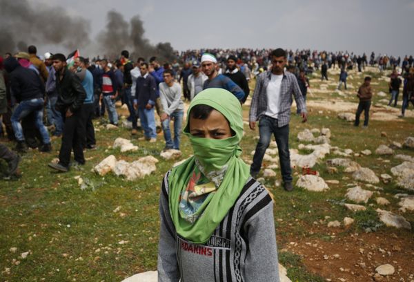 A young Palestinian protestor poses for a photo during clashes with Israeli security forces following a demonstration against Jewish settlements in village of al-Mughayyir, near the West Bank city of Ramallah, on March 24, 2017 A young Palestinian protestor poses for a photo during clashes with Israeli security forces following a demonstration against Jewish settlements in village of al-Mughayyir, near the West Bank city of Ramallah, on March 24, 2017 - Sputnik International
