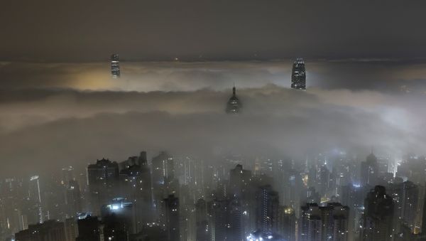 High-rise buildings are partly covered by heavy fog at Hong Kong's Victoria Harbour Monday, March 20, 2017. - Sputnik International