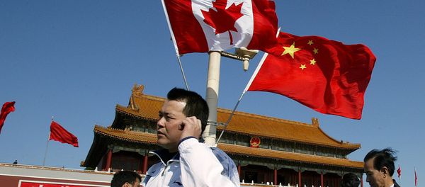 A man walks past flags of Canada and China in front of Tiananmen Gate in Beijing (File) A man walks past flags of Canada and China in front of Tiananmen Gate in Beijing (File) - Sputnik International