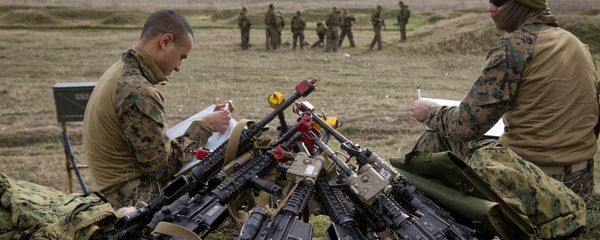 US Marines sit by a pile of assault rifles US Marines sit by a pile of assault rifles - Sputnik International