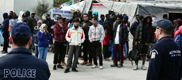 A picture taken on March 16, 2017 shows policemen standing guard near migrants at the Moria migrant camp on the island of Lesbos, almost a year after an EU-Turkey deal A picture taken on March 16, 2017 shows policemen standing guard near migrants at the Moria migrant camp on the island of Lesbos, almost a year after an EU-Turkey deal - Sputnik International