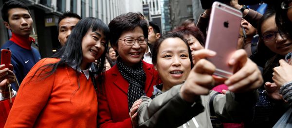 People take selfies with Carrie Lam, chief executive-elect, a day after she was elected in Hong Kong, China March 27, 2017 - Sputnik International